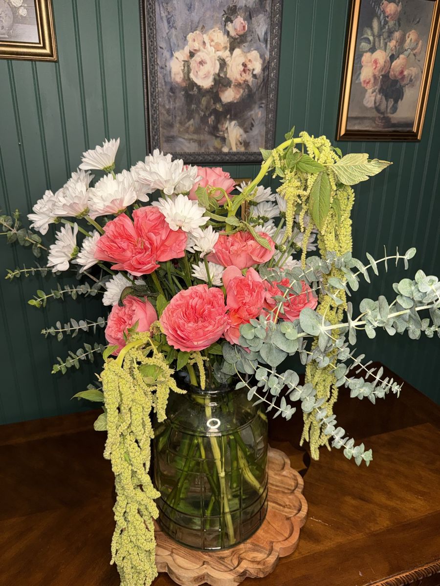 Coral garden roses, white daisies, eucalyptus and hanging amaranthus